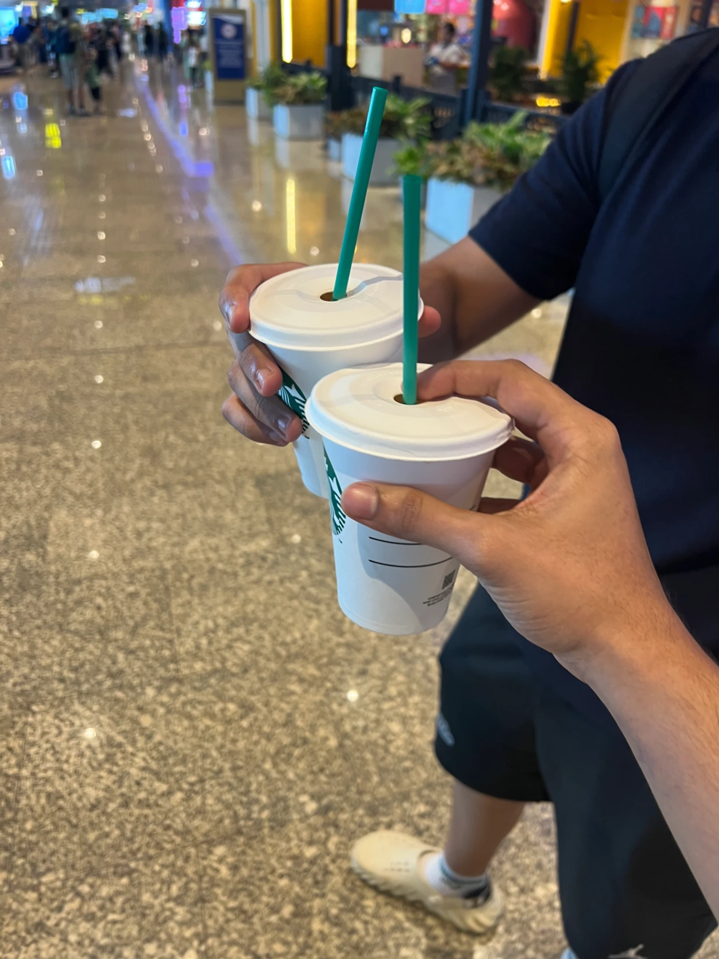 Naman Dudeja with a co-founder holding coffee cups — the everyday moments behind Drome Media